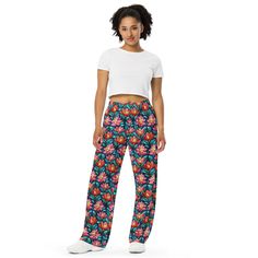 Upgrade your loungewear with our All-Over-Print Unisex Wide-Leg Pants, designed for ultimate comfort and style. These best-selling pants effortlessly blend fashion with function, making them perfect for everything from cozy pajamas to trendy streetwear. Whether you're lounging at home or stepping out, their super soft, stretchy fabric ensures comfort in every move. Crafted with premium knit mid-weight jersey fabric, these pants feature a relaxed unisex fit and an adjustable elastic waistband with a white drawstring for added comfort. Plus, the practical side pockets make them ideal for daily wear. Choose to wear them on the waist or hips for a customizable fit. The fabric's OEKO-TEX 100 standard certification guarantees safe, eco-friendly material that's gentle on the skin. Whether you're Window Flowers, Floral Lounge, Flower Pants, Pants Gift, Cozy Pajamas, Trendy Streetwear, Pants Elastic Waist, Pj Pants, Stained Glass Window