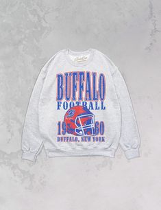 Show the love for your favorite team on game day in this Buffalo, New York Football oversized crewneck that is inspired by vintage 90s N F L sweatshirts!- Features Buffalo across the top with a football helmet and 1960 with Buffalo, New York underneath all in a blue and red ink- Heat print transfer that is heat pressed onto each sweatshirt- Printed on a soft, 90's style oversized crewneck sweatshirt- Cotton / Poly Blend- Super oversized fit- Sizing translation: XS/S = L , S/M = XL , L/XL = 2XL , Vintage Football Crewneck, Vintage Varsity Sweatshirt, Retro Sweatshirt For Game Day, Sports Season, Retro Sweatshirt For Game Day And Sports Season, Retro Sweatshirt For Game Day, Retro Game Day Sweatshirt With Letter Print, Retro Graphic Print Sweatshirt For Game Day, Vintage Letter Print Sweatshirt For Fan Gear, Vintage Letter Print Sweatshirt For Game Day