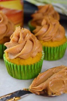 three cupcakes with peanut butter frosting on them