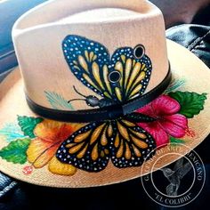 a hat with butterflies painted on it