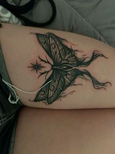 a woman's thigh with a butterfly tattoo on it