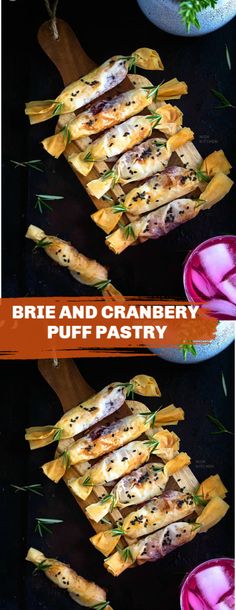 cranberry and brie filo crackers on a black surface with herbs