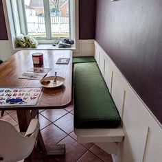 a table and bench in a small room