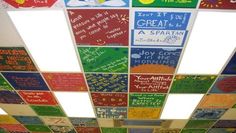 the ceiling is decorated with many different colored signs and phrases on it's sides