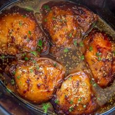 chicken thighs in a slow cooker with spices and seasoning on the side, ready to be cooked