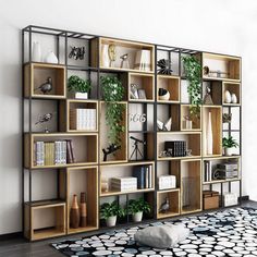 a living room filled with lots of bookshelves next to a black and white rug