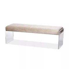 a bench that is sitting in front of a white wall and has a clear frame around it