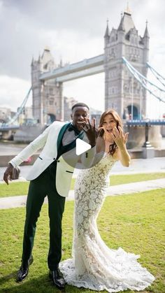 a bride and groom posing in front of the london tower bridge for their wedding video