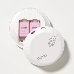 two pink batteries in a white container on a white surface with the word pura printed on it