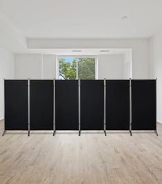 an empty room with black partitions in the middle