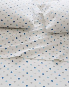 a bed with blue and white polka dots on it