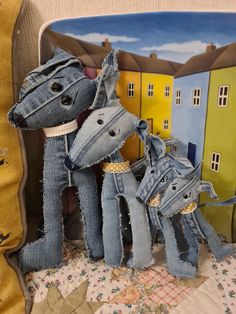 two stuffed animals made out of jeans sitting next to each other