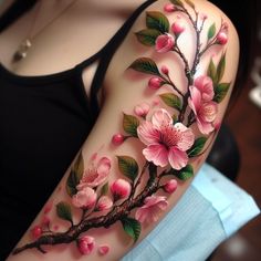 a woman's arm with pink flowers and leaves painted on the side of her body