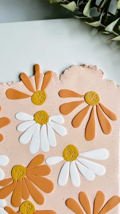 an orange and white cake with flowers on it