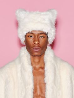 The signature hat style of the capsule features a square silhouette that, when worn, appears subtly as two ears. Crafted of soft faux fur, it has a textural feel that adds volume to the silhouette. Sourced from the leading ethical fur manufacturer, ECOPEL, this luxurious fiber is crafted with sustainability in mind as a worthy alternative to animal-sourced fur. Designed with a soft and lustrous feel, it is the optimal fabrication for the Faux Fur Hat and Faux Fur Jacket in which it features, ens Fur Trench Coat, Faux Fur Hat, Rosetta Getty, Hat Style, Fur Hat, Fur Fashion, Faux Fur Jacket, Trench Coats, Square Shape