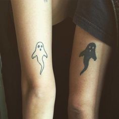 two people with matching tattoos on their arms, one has a ghost and the other has a ghost