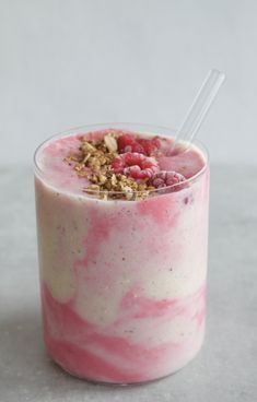 a drink with raspberries and granola in it