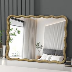 a mirror that is sitting on top of a shelf next to a bed and vase