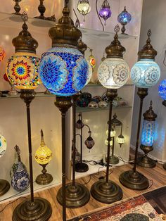 many different colored lamps on display in a store