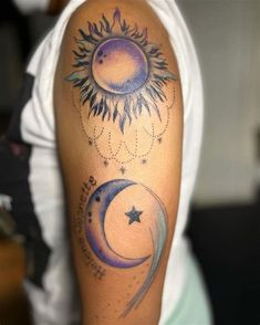 a person with a tattoo on their arm that has the sun and moon in it