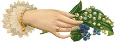 a woman's hand holding a bunch of blue flowers with green leaves on it