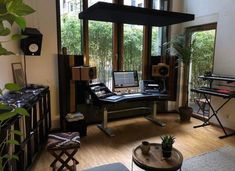 a living room filled with lots of furniture next to a large window covered in plants