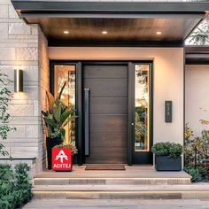 the front entrance to a modern home with a red sign