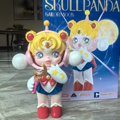 a toy figurine is shown next to a box for the game sailor moon