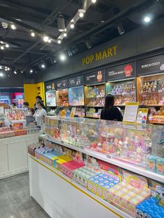 the inside of a toy store filled with lots of toys and people looking at them