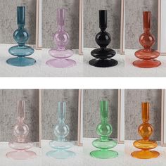 several different colored glass vases sitting next to each other