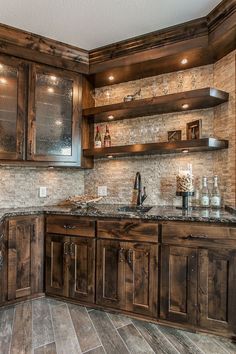 a kitchen with wooden cabinets and marble counter tops