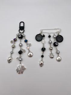 two pairs of black and white beaded earrings with charms attached to the earwires