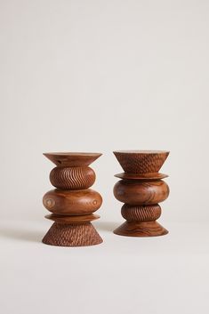 two wooden candlesticks sitting on top of each other