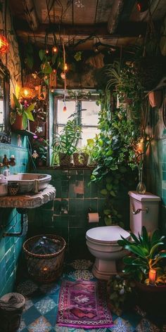 a bathroom with plants hanging from the ceiling and a rug on the floor next to the toilet