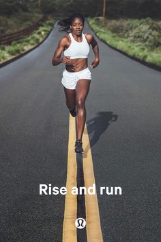 a woman running down the middle of an empty road