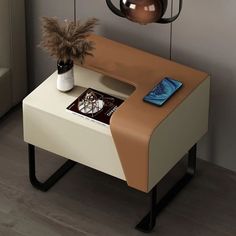 a small table with a phone on it next to a potted plant