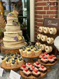 a table topped with lots of different types of cakes and cupcakes next to each other