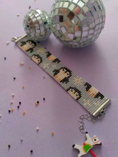 the beaded bracelet is next to two disco balls