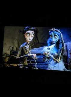 the corpse girl and jack skellingy are in front of a large screen with skeletons on it