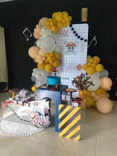 there is a table with balloons and decorations in the room that has been set up for a party