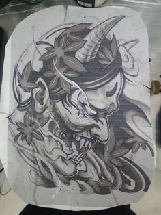 a drawing of a demon with horns on it's head is shown in front of a mirror