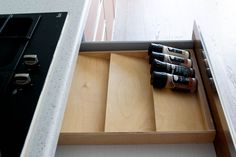 an open drawer with several bottles in it