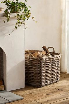 a wicker basket next to a fireplace