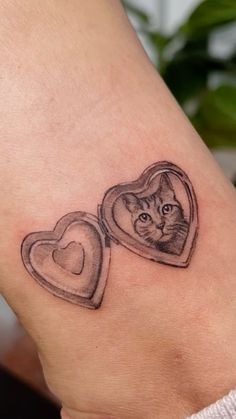 a small cat in a heart shaped box tattoo on the right side of the leg