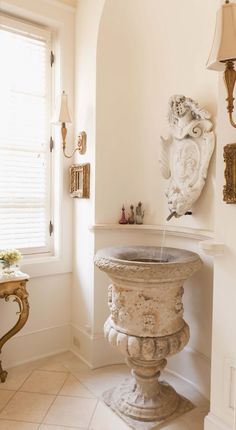 a white pedestal sink in a bathroom next to a window