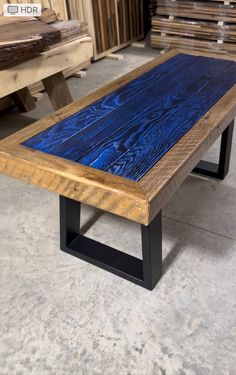 a wooden table sitting on top of a cement floor