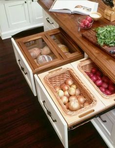 an open drawer in the middle of a kitchen counter with vegetables and fruit inside it