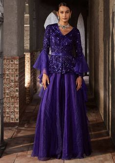 This gorgeous purple sharara with full sleeves has geometric embroidery with front open. It is paired with organza sharara. The outfit is completed with frill dupatta and belt. Purple Palazzo Set With Sheer Dupatta For Diwali, Bollywood Style Ruffled Palazzo Set For Party, Eid Party Anarkali Set With Ruffles, Eid Party Palazzo Set With Ruffles, Designer Long Sleeve Purple Palazzo Set, Bollywood Style Long Sleeve Sharara In Organza, Elegant Purple Palazzo Set For Festive Occasions, Elegant Purple Long Sleeve Anarkali Set, Elegant Purple Long Sleeve Palazzo Set