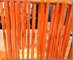 an orange chair with wooden slats on it