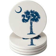 four coasters with palm trees and the moon on them, all painted in blue